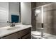 Bathroom with single sink vanity, toilet, frosted glass shower door, and mirror, creating a practical and private space at 14818 Autumn View Way, Fishers, IN 46037