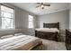 Spacious bedroom with a ceiling fan, two large windows providing natural light, and a large, comfortable bed at 14818 Autumn View Way, Fishers, IN 46037