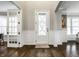 Elegant foyer with hardwood floors, a decorative glass door, and paneled walls at 14818 Autumn View Way, Fishers, IN 46037