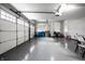 Clean garage with epoxy floors, overhead door with opener system, and bright natural light at 14818 Autumn View Way, Fishers, IN 46037