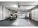 Finished garage featuring epoxy floors, kitchen area, and overhead door with opener system at 14818 Autumn View Way, Fishers, IN 46037