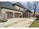 Spacious three-car garage featuring brick facade and modern doors, providing ample parking at 14818 Autumn View Way, Fishers, IN 46037