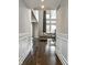 Inviting hallway leading to a bright living area with large windows and comfortable seating at 14818 Autumn View Way, Fishers, IN 46037