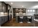Modern kitchen featuring stainless steel appliances, a large island with seating, and dark wood cabinets at 14818 Autumn View Way, Fishers, IN 46037