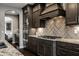 Contemporary kitchen featuring dark cabinets, stainless appliances, granite counters, and a modern tile backsplash at 14818 Autumn View Way, Fishers, IN 46037