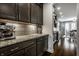 Featuring granite countertops, dark cabinets, stainless appliances, and hardwood floors for an upscale look at 14818 Autumn View Way, Fishers, IN 46037