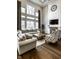 Bright living room with high ceilings, large windows, fireplace, and hardwood floors creating an inviting atmosphere at 14818 Autumn View Way, Fishers, IN 46037