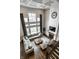 Aerial view of the living room showcases the tall windows, fireplace, and hardwood floors at 14818 Autumn View Way, Fishers, IN 46037