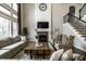 Elegant living room featuring a fireplace, high ceilings, and comfortable seating at 14818 Autumn View Way, Fishers, IN 46037
