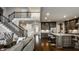Open-concept living space with stairs, kitchen island, and comfortable seating area at 14818 Autumn View Way, Fishers, IN 46037