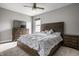 Cozy bedroom featuring a large bed, two matching nightstands, a dresser, and plenty of natural light at 14818 Autumn View Way, Fishers, IN 46037
