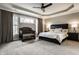 Serene main bedroom with a tray ceiling, soft lighting, a crib, and large windows creating a tranquil atmosphere at 14818 Autumn View Way, Fishers, IN 46037