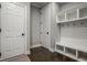 Functional mudroom with a built-in bench, coat hooks, and storage compartments for organizing shoes, bags, and outdoor gear at 14818 Autumn View Way, Fishers, IN 46037