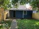 Backyard featuring a grassy area, wooden fence, and access door at 1518 Lawton Ave, Indianapolis, IN 46203