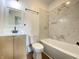 Bright bathroom with marble tiled shower and a modern wood vanity at 1518 Lawton Ave, Indianapolis, IN 46203