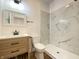 Bright bathroom featuring marble tiled shower and backsplash with a wood vanity at 1518 Lawton Ave, Indianapolis, IN 46203