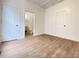 Bedroom with wood flooring, white trim, and two closet doors offering ample storage space at 1518 Lawton Ave, Indianapolis, IN 46203