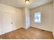 Bright bedroom with wood floors, white walls, and two white doors at 1518 Lawton Ave, Indianapolis, IN 46203
