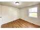 Cozy bedroom features wood flooring, neutral paint, natural light, and base molding throughout at 1518 Lawton Ave, Indianapolis, IN 46203