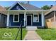 Charming blue home with a covered front porch, white pillars, and walkway at 1518 Lawton Ave, Indianapolis, IN 46203