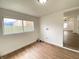 Functional laundry room with a window and wood flooring; washer and dryer hookups available at 1518 Lawton Ave, Indianapolis, IN 46203