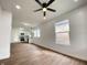 Living room with wood floors, white walls, a ceiling fan and an open view to the kitchen at 1518 Lawton Ave, Indianapolis, IN 46203