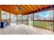 Covered back porch with brick flooring, wooden ceiling, and outdoor fan overlooking the backyard at 1521 Pleasant St, Indianapolis, IN 46203