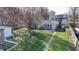 Aerial view of the backyard shows a spacious lawn, a brick walkway, and mature trees at 1521 Pleasant St, Indianapolis, IN 46203