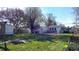 The grassy backyard features a shed, trees, and daffodils at 1521 Pleasant St, Indianapolis, IN 46203