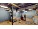 Unfinished basement featuring exposed pipes, concrete floors, and blue painted walls at 1521 Pleasant St, Indianapolis, IN 46203