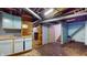 Unfinished basement with painted walls, utility pipes, and retro light blue cabinets at 1521 Pleasant St, Indianapolis, IN 46203