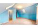 Bright bedroom featuring blue walls, carpeted floors, a skylight, and a closet at 1521 Pleasant St, Indianapolis, IN 46203
