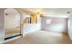 Bonus room with carpet flooring, window, and steps at 1521 Pleasant St, Indianapolis, IN 46203