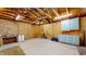 Spacious unfinished garage with concrete floor, exposed rafters and storage cabinets at 1521 Pleasant St, Indianapolis, IN 46203