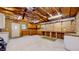 Unfinished garage featuring built in cabinets, concrete floor, and exposed rafters at 1521 Pleasant St, Indianapolis, IN 46203