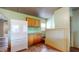 Functional kitchen design with wood cabinets, laminate countertops, and white appliances at 1521 Pleasant St, Indianapolis, IN 46203