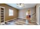 A bright living room features a built-in bookshelf, ceiling fan, and hardwood floors at 1521 Pleasant St, Indianapolis, IN 46203