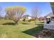 Expansive backyard with mature trees and lush lawn provides plenty of space for outdoor activities and relaxation at 17279 Crescent Moon Dr, Noblesville, IN 46060