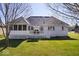 Well-maintained backyard with a white picket fence, patio area, and lush green lawn at 17279 Crescent Moon Dr, Noblesville, IN 46060
