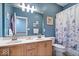 Well-lit bathroom with double sinks, wood cabinets, and a decorative shower curtain at 17279 Crescent Moon Dr, Noblesville, IN 46060