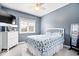 Cozy bedroom featuring light blue walls, plush carpet, and a large window at 17279 Crescent Moon Dr, Noblesville, IN 46060