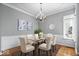 Formal dining room with wainscoting, chandelier, and a modern glass table set for six at 17279 Crescent Moon Dr, Noblesville, IN 46060