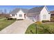 Charming single-Gathering home featuring a well-manicured lawn and an attached two-car garage at 17279 Crescent Moon Dr, Noblesville, IN 46060