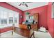 This home office has a large wooden desk and matching cabinet with ample natural light at 17279 Crescent Moon Dr, Noblesville, IN 46060
