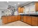 Functional kitchen featuring stainless steel appliances, wooden cabinetry, and a convenient layout at 17279 Crescent Moon Dr, Noblesville, IN 46060