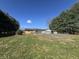 Expansive backyard with mature trees and partial fencing offers a private outdoor retreat and potential for gardening at 2115 Leonard Rd, Martinsville, IN 46151