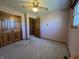 Bedroom with carpet, a ceiling fan, natural light, and a wood-trimmed closet at 2115 Leonard Rd, Martinsville, IN 46151