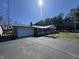 Ranch home with brick and metal roof, showcasing a charming curb appeal, garage, and well-maintained landscaping at 2115 Leonard Rd, Martinsville, IN 46151