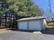 Two car detached garage with blacktop driveway and treeline at 2115 Leonard Rd, Martinsville, IN 46151