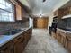 Kitchen with wood cabinets, double sink, tile backsplash and view to an adjacent room at 2115 Leonard Rd, Martinsville, IN 46151